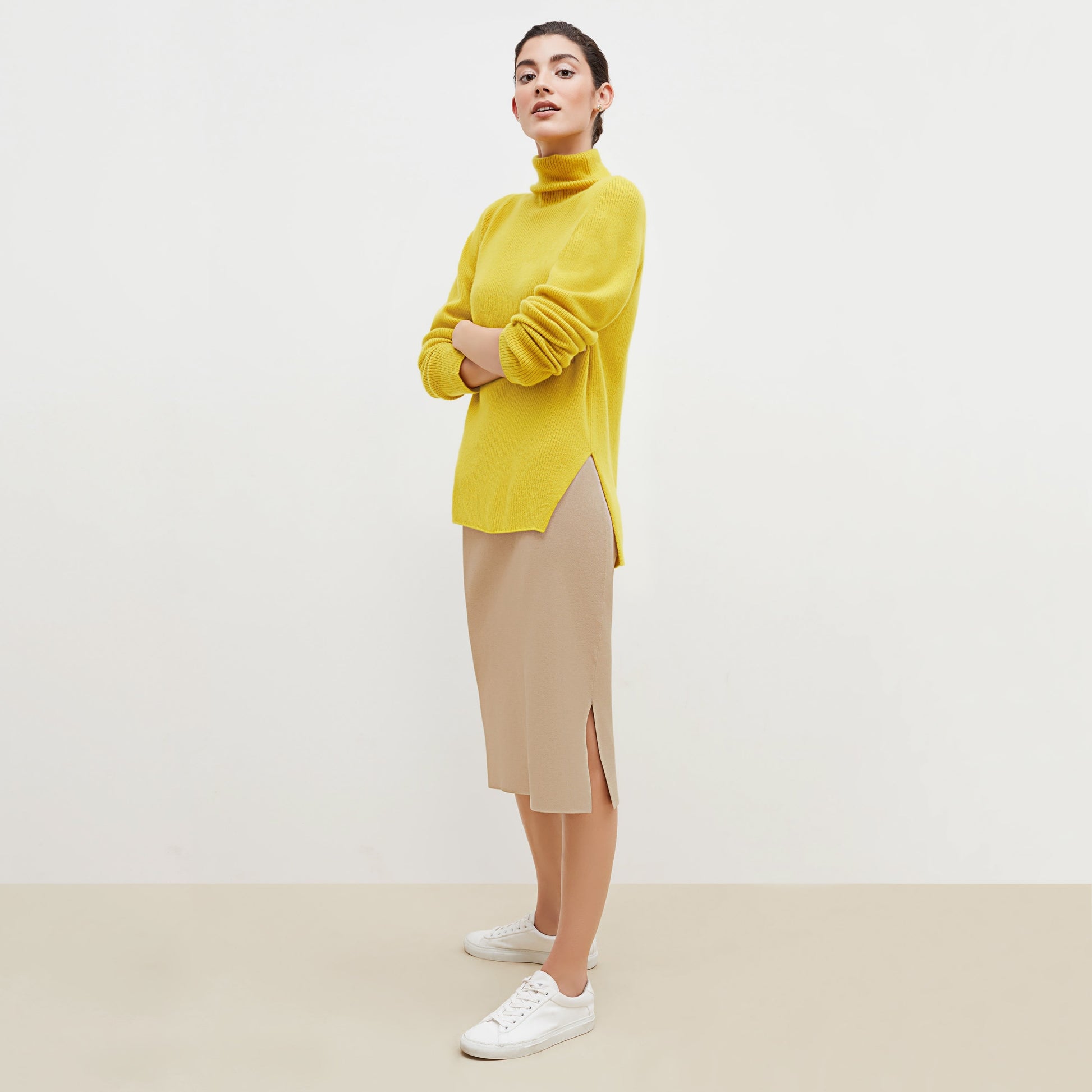 Side image of a woman standing wearing the Harlem skirt in latte | Exclude