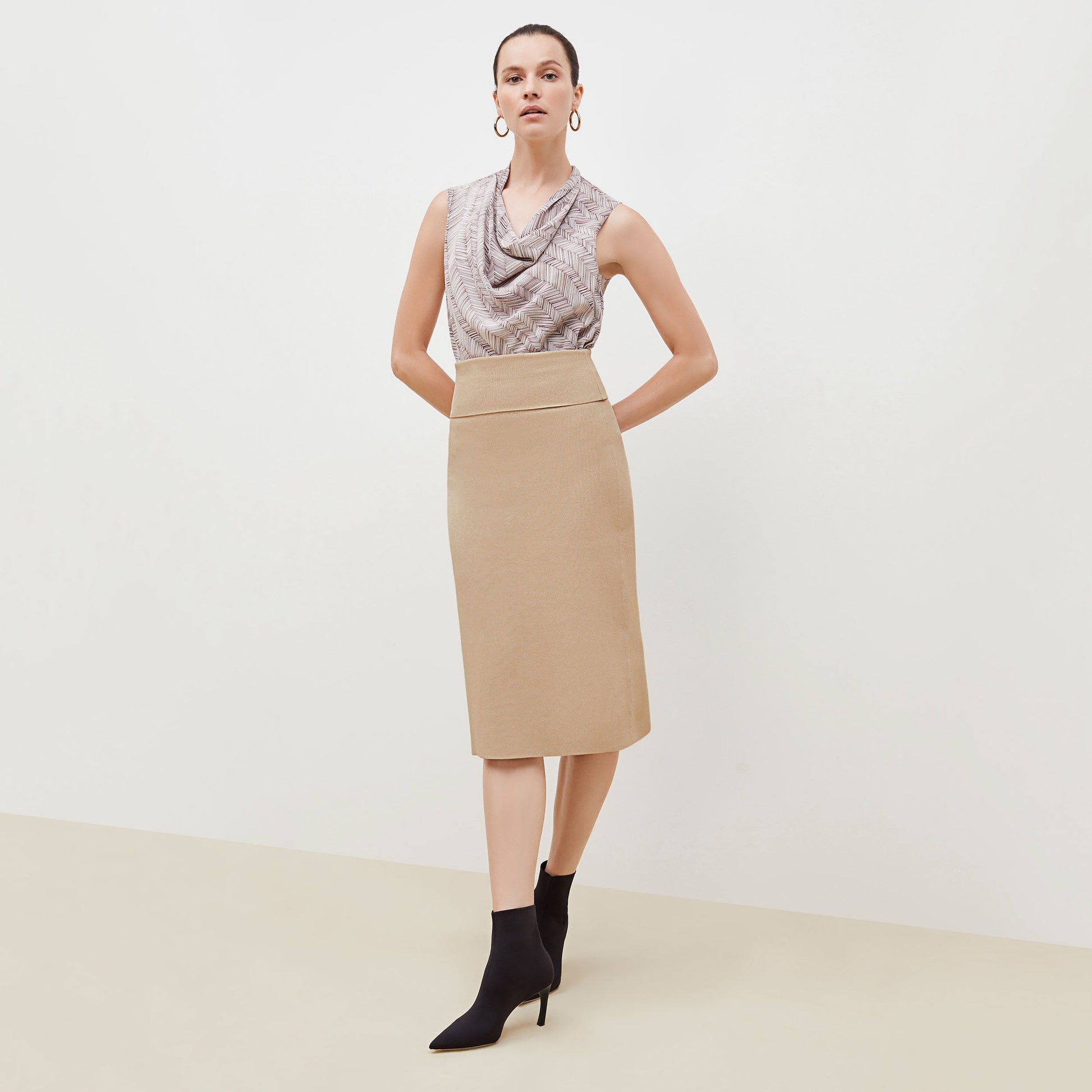 Front image of a woman standing wearing the Harlem skirt in latte | Exclude