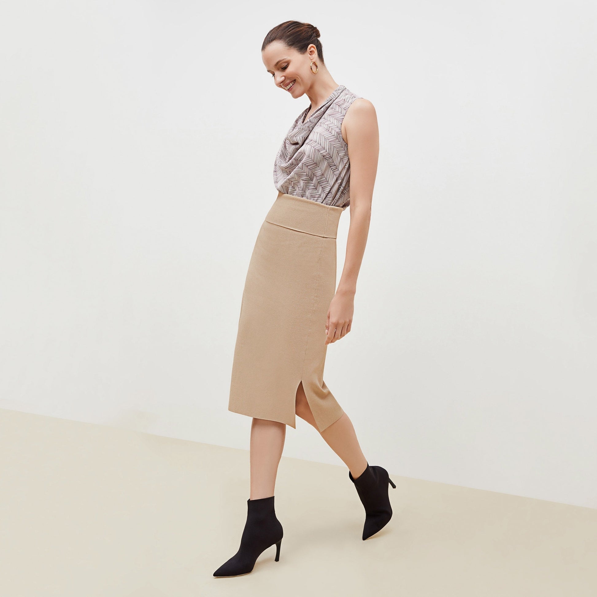 Side image of a woman standing wearing the Harlem skirt in latte | Exclude