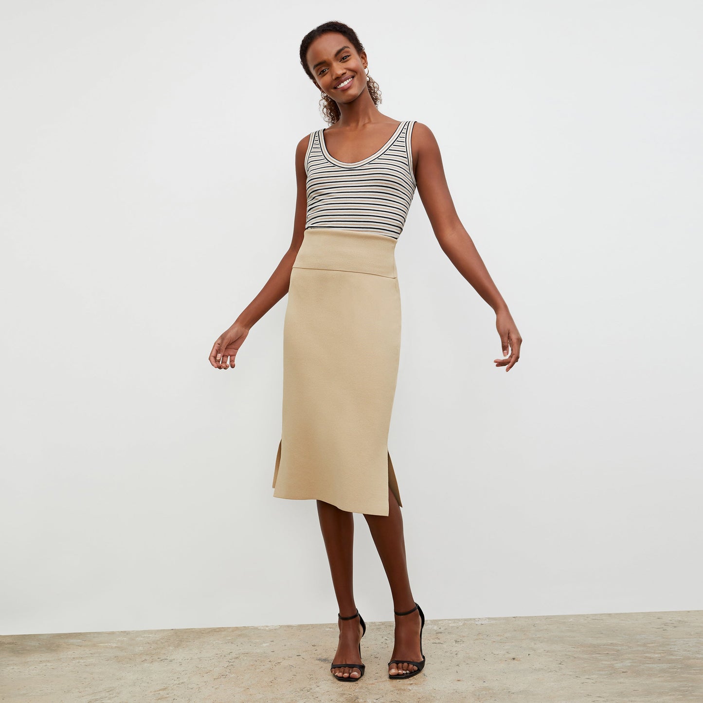 Front image of a woman standing wearing the Harlem skirt in latte | Exclude