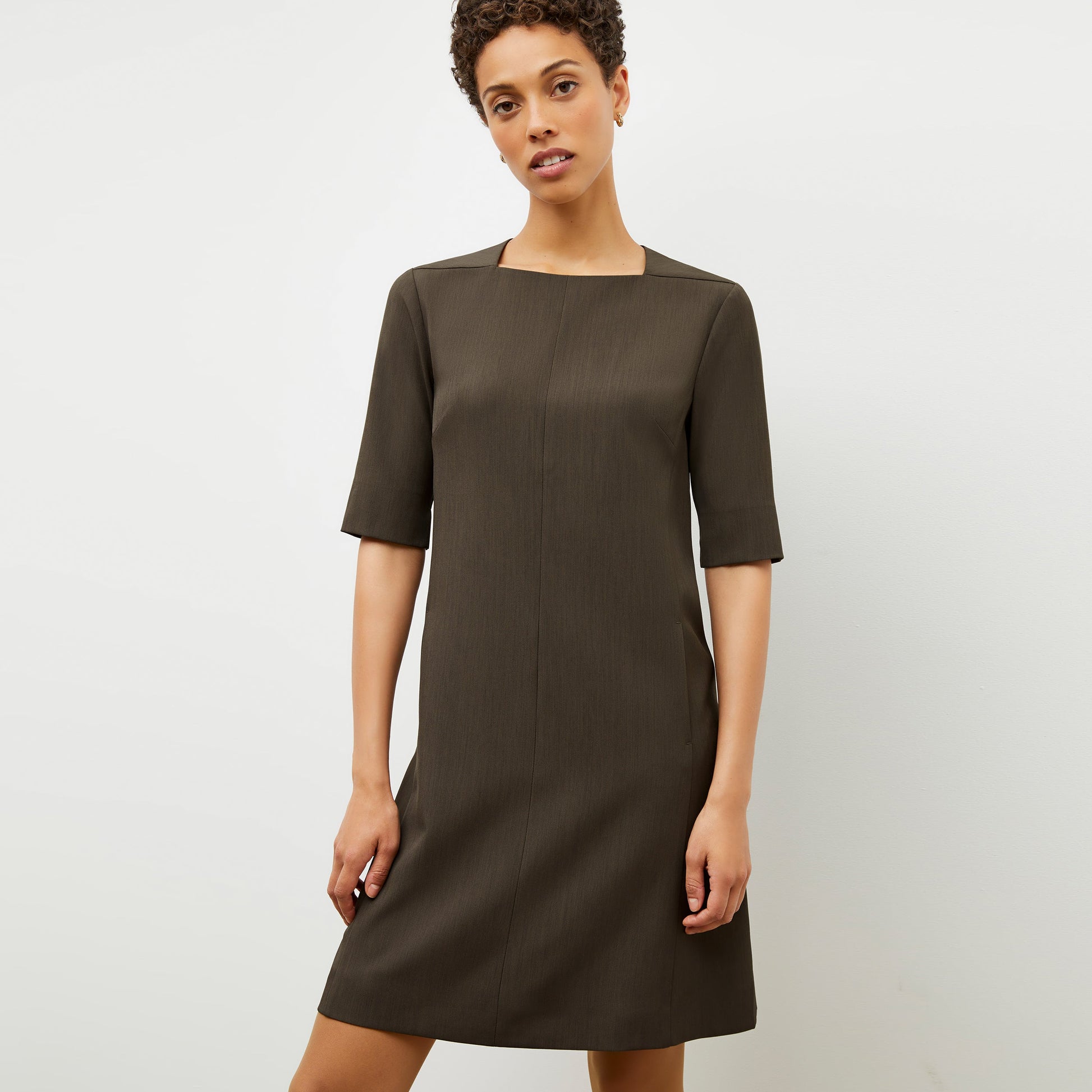 Front image of a woman wearing the emily dress in kale | Lead