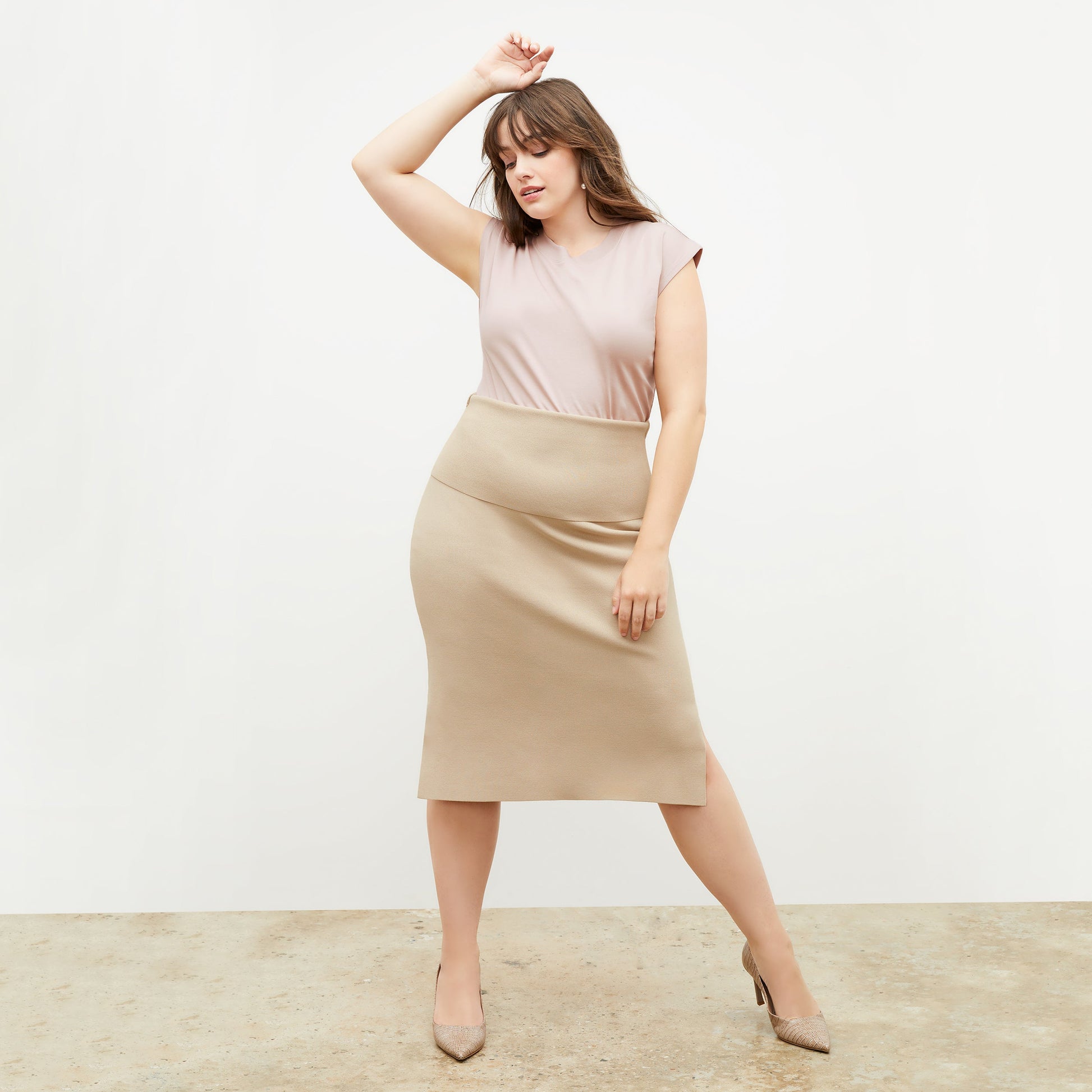 Front image of a woman standing wearing the Harlem skirt in latte