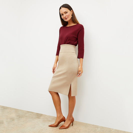 Front image of a woman standing wearing the Harlem skirt in latte | Lead