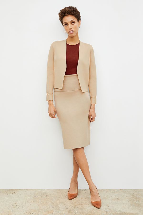 Front image of a woman standing wearing the Harlem skirt in latte | Exclude